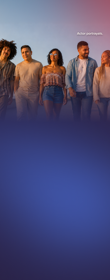 A group of people standing laughing and smiling.