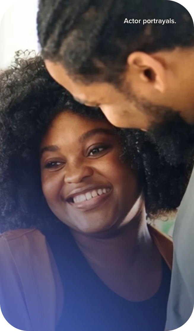 Couple smiling while holding each other.