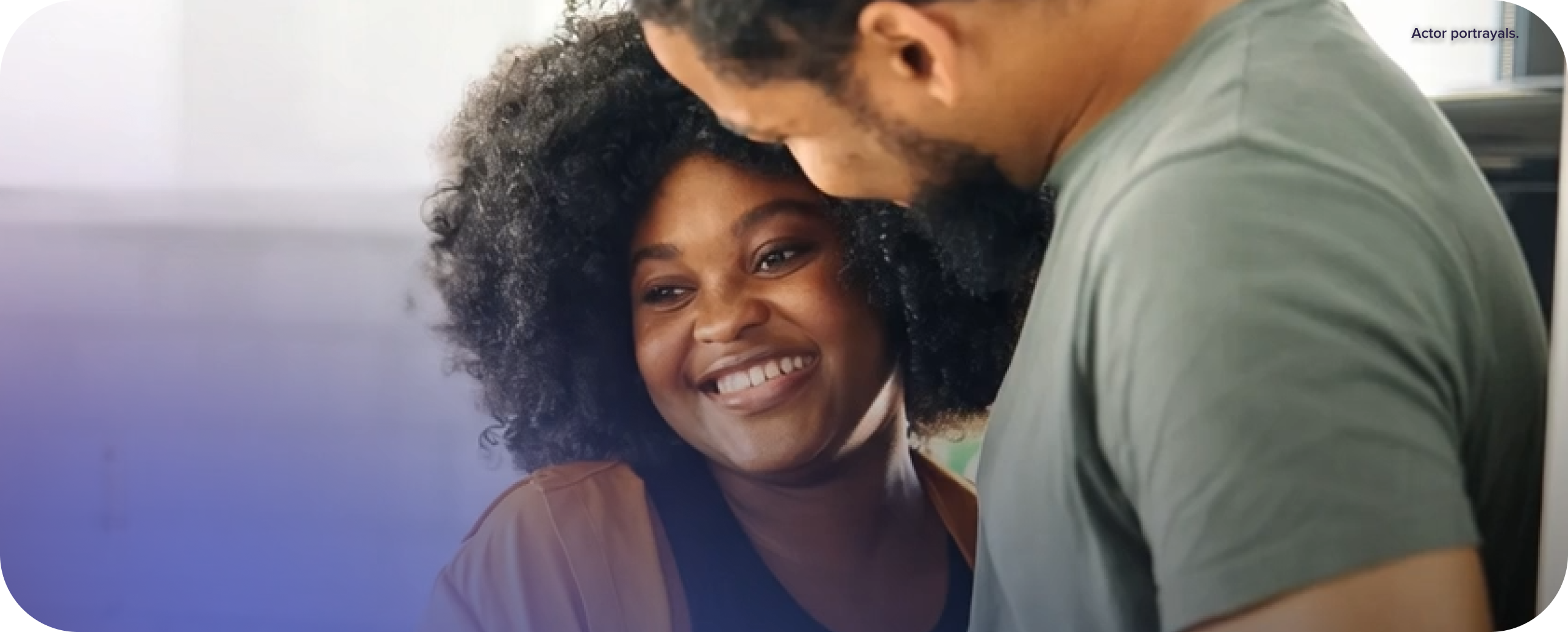 Couple smiling while holding each other.